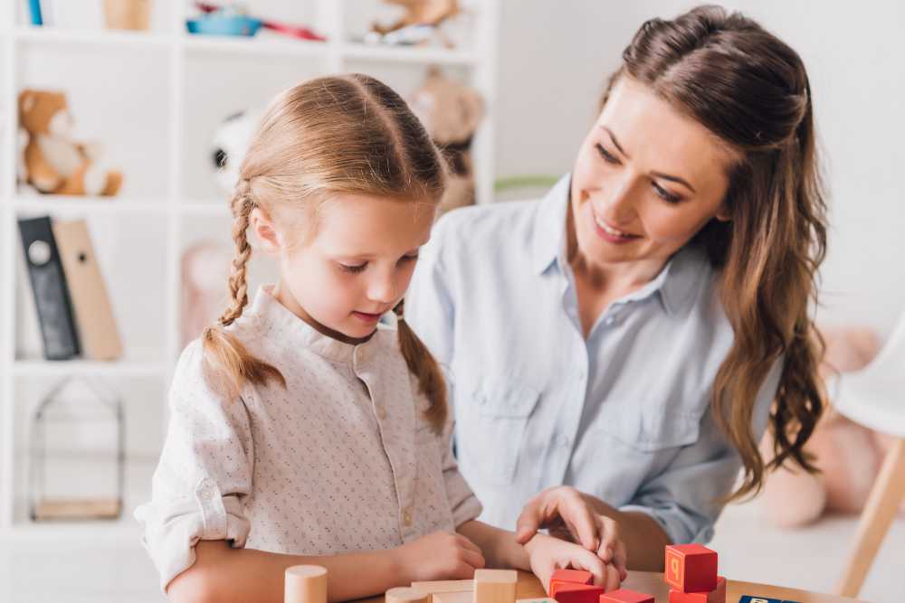 Happy mother playing blocks with little child