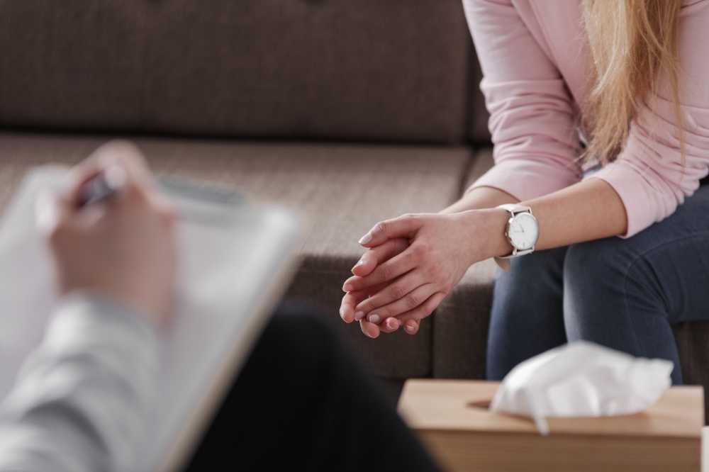 Close-up of woman's hands during counseling meeting with a professional therapist.